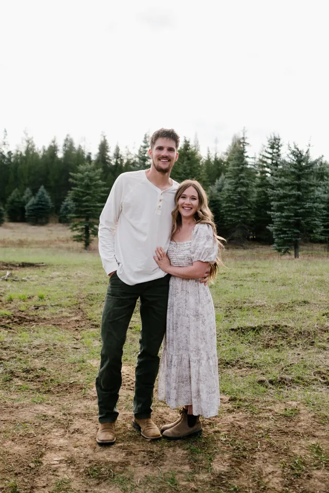 Judah and Belle Draxlir standing together in a meadow